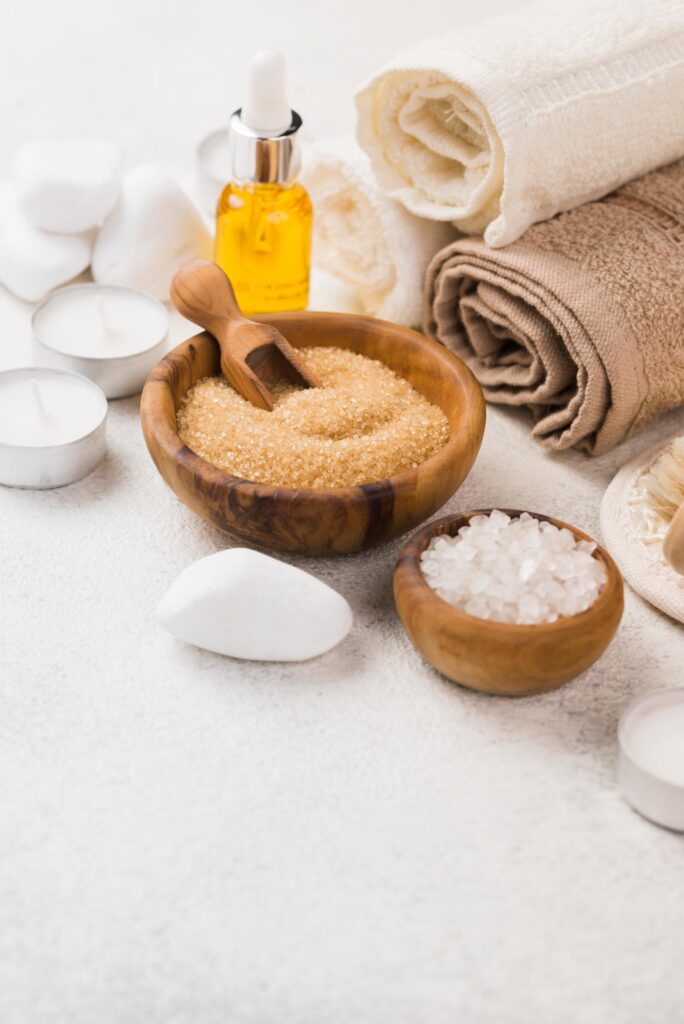 Close up of spa accessories with oils and towels.