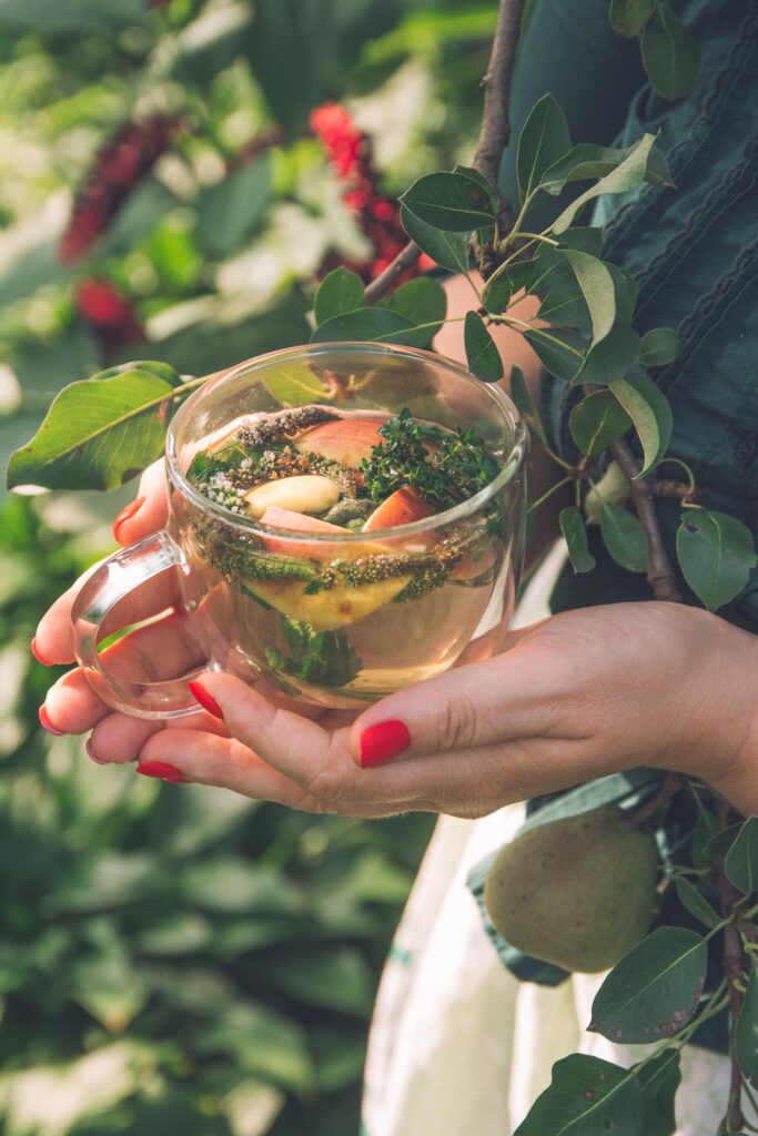 women holding a cup of herbal tea